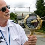 Steve Jackson shepherds riders through the gate at the Edmonds ferry terminal. (Kevin Clark / The Herald)