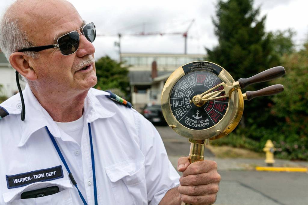 Steve Jackson shepherds riders through the gate at the Edmonds ferry terminal. (Kevin Clark / The Herald)