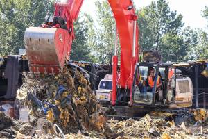 Demolition crews work to dismantle the McDonalds Furniture Showroom Wednesday morning in Lynnwood on July 25, 2018. It marks the first construction activity on the light-rail expansion in Snohomish County. (Kevin Clark / The Herald)