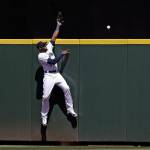 Mariners center fielder Cameron Maybin leaps but cant reach a home run by the Astros Max Stassi during the fifth inning on Aug. 1, 2018, in Seattle. (AP Photo/Elaine Thompson)