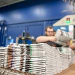 In this April 11 photo, production workers stack newspapers onto a cart at the Janesville Gazette Printing & Distribution plant in Janesville, Wisconsin. (Angela Major/The Janesville Gazette via AP, File)