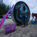 Casey Varner and Monica Conners play with a giant art installation on Thursday in Darrington. (Olivia Vanni / The Herald)