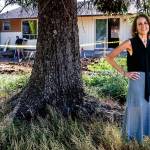 Tracy Rubstello, director of development for the Bridge Receiving Center (background), talks about the home being created as a 30-day refuge for children who are first entering foster care. (Dan Bates / The Herald)