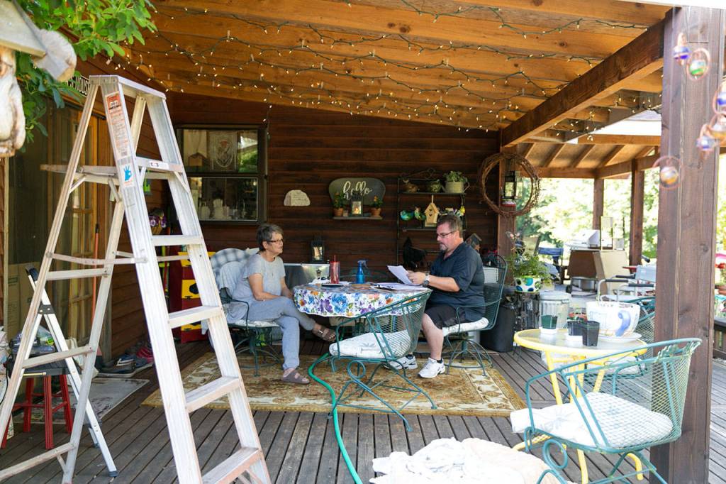 Stacy Brewer (right) talks with Susan Fenner about a proposed annexation to the city of Lake Stevens. (Kevin Clark / The Herald)