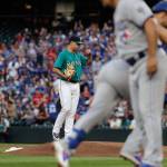 Mariners starting pitcher Marco Gonzales stands on the mound as the Blue Jays Devon Travis is greeted by third base coach Luis Rivera after Travis hit a two-run home run during the fifth inning on Aug. 3, 2018, in Seattle. (AP Photo/Ted S. Warren)
