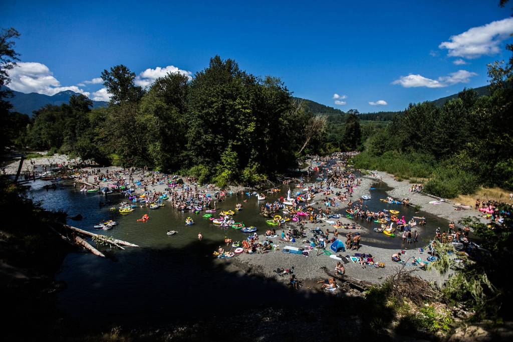 People enjoy the North Fork Stillaguamish River at the Summer Meltdown on Saturday, Aug. 4, 2018 in Darrington. (Olivia Vanni / The Herald)