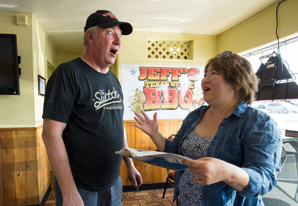 Jeff Knoch, owner of Jeffs Texas Style BBQ, reacts as customer Robin Young calls him The Donny Osmond of barbecue on Aug. 8. Young drove all the way from Covington to arrive first in line and get Knochs autograph. (Andy Bronson / The Herald)