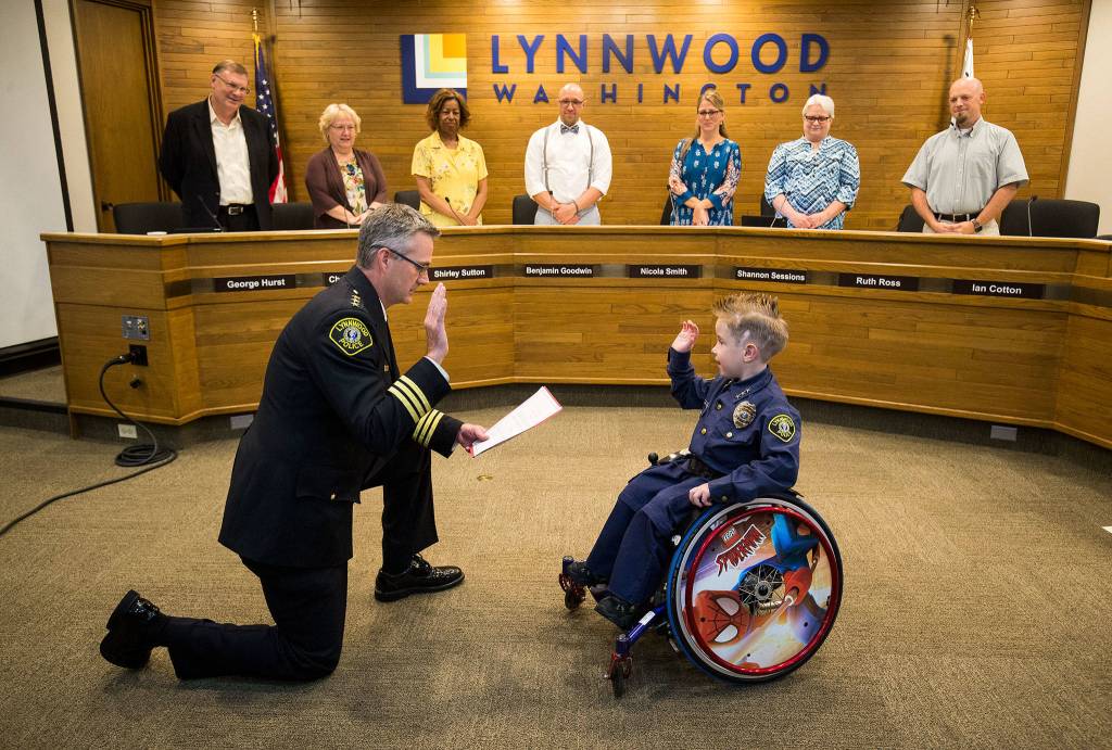 Chief for a Day Luca Keogh, 7, is sworn in as chief by Lynnwood Police Chief Tom Davis during a City Council meeting on Monday. Its Lynnwoods first time doing this. Keogh has been diagnosed with spina bifida, hydrocephalus, slit ventricle syndrome, chiari malformation and tethered cord syndrome. (Andy Bronson / The Herald)