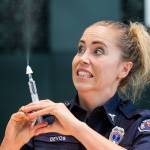 Lynnwood firefighter/paramedic Dani DeVos reacts Friday as she teaches staff of Edmonds School District how to administer Narcan via an intranasal device during ACT Training at Edmonds-Woodway High School. (Andy Bronson / The Herald)