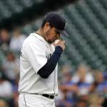 Mariners starting pitcher Felix Hernandez makes a crossing gesture while he holds the baseball as he takes the mound during a game against the Blue Jays on Aug. 2, 2018, in Seattle. (AP Photo/Ted S. Warren)