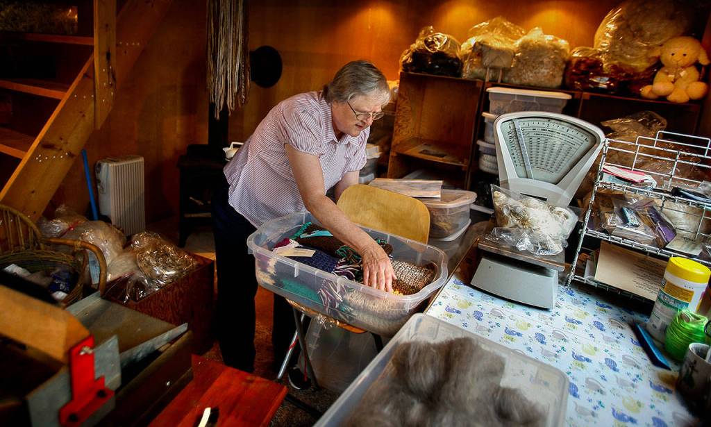 In her wool shop, which she bought at the fair, Elaine Wilson has some fine wool products, including her handmade scarves. (Dan Bates / The Herald)