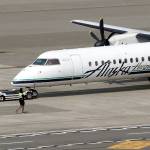 A Horizon Air Q400 turboprop airplane, like the one stolen and crashed Friday, is moved into position by airport workers at Seattle-Tacoma International Airport on Monday. (AP Photo/Elaine Thompson)