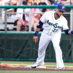 Robinson Cano, playing for the Everett AquaSox on Aug. 9, catches a pickoff throw at first base as Eugenes Jake Slaughter slides in safely at Everett Memorial Stadium. Cano is eligible to return to the Mariners on Tuesday. (Kevin Clark / The Herald)
