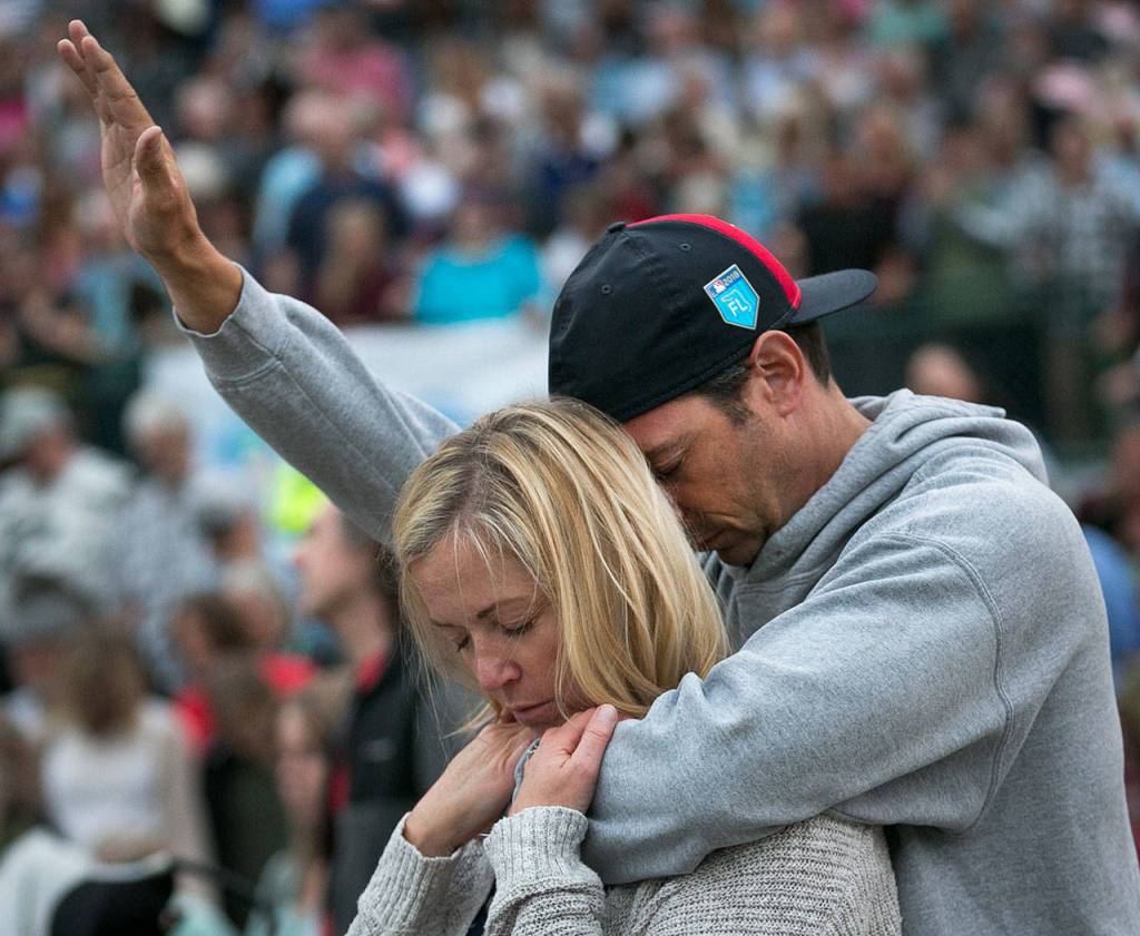 Trina and Bobby Morrison pray during the Decision America Pacific Northwest Tour on Monday night at the Evergreen State Fairgrounds in Monroe. (Kevin Clark / The Herald)