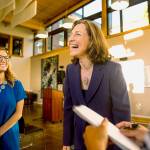 Eighth Congressional District Candidate Kim Schrier laughs about her hectic day while answering a swarm of questions at her election watch party in Issaquah the night of the primary, Aug. 7. (Rebekah Welch/The Seattle Times via AP)