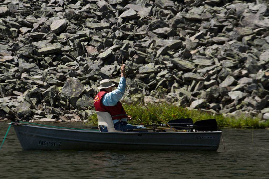 Pat ONeil of Everett rigs a line to prepare fishing in Leech Lake. (Mike Benbow photo)