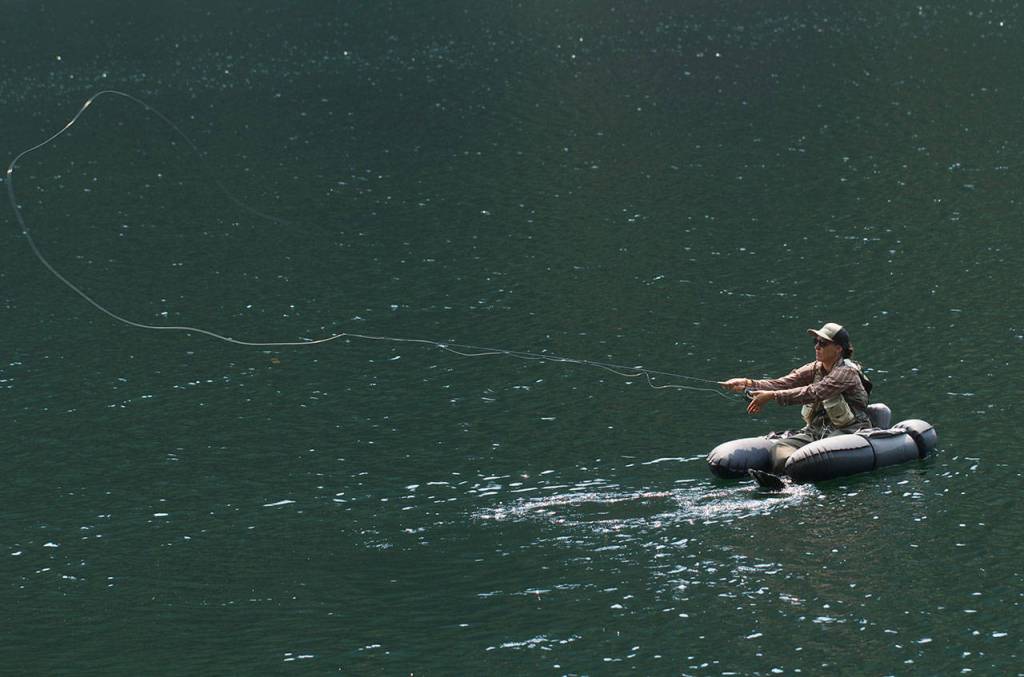Anna Oenbring of Granite Falls casts a fly into the clear waters of Slide Lake. (Mike Benbow photo)