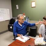 Geoff Godfrey, (left) a nurse practitioner at Ideal Option, talks with Curtis Letzkus (right) about his treatment plan. (Lizz Giordano / The Herald)
