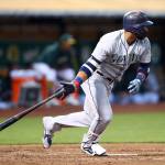 Seattles Robinson Cano hits a single in the third inning of Tuesdays game in Oakland, Calif. (AP Photo/Ben Margot)