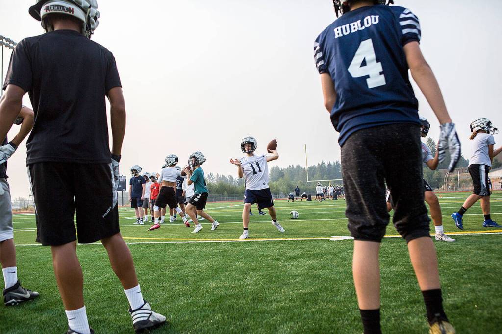 Jadon Claps, center, throws the ball during football practice at Glacier Peak High School on Aug. 15, 2018 in Snohomish, Wa. (Olivia Vanni / The Herald)