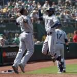 Seattles Dee Gordon (right) celebrates with teammate Jean Segura after hitting a two-run home run during the 12th inning of Wednesdays game in Oakland, Calif. (AP Photo/Jeff Chiu)