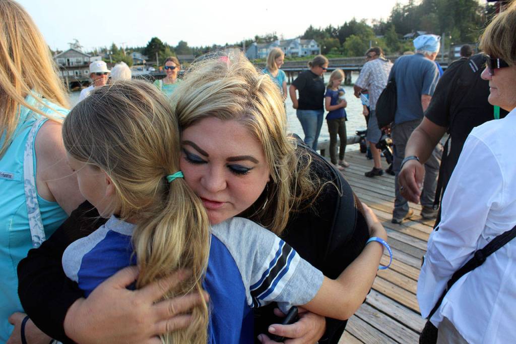 Michelle Seidelman, with Sea Shepherd in Portland, makes the round of hugs that ended the somber event. She travels to the Bring Tokitae Home gathering every year. (Patricia Guthrie/Whidbey News-Times)