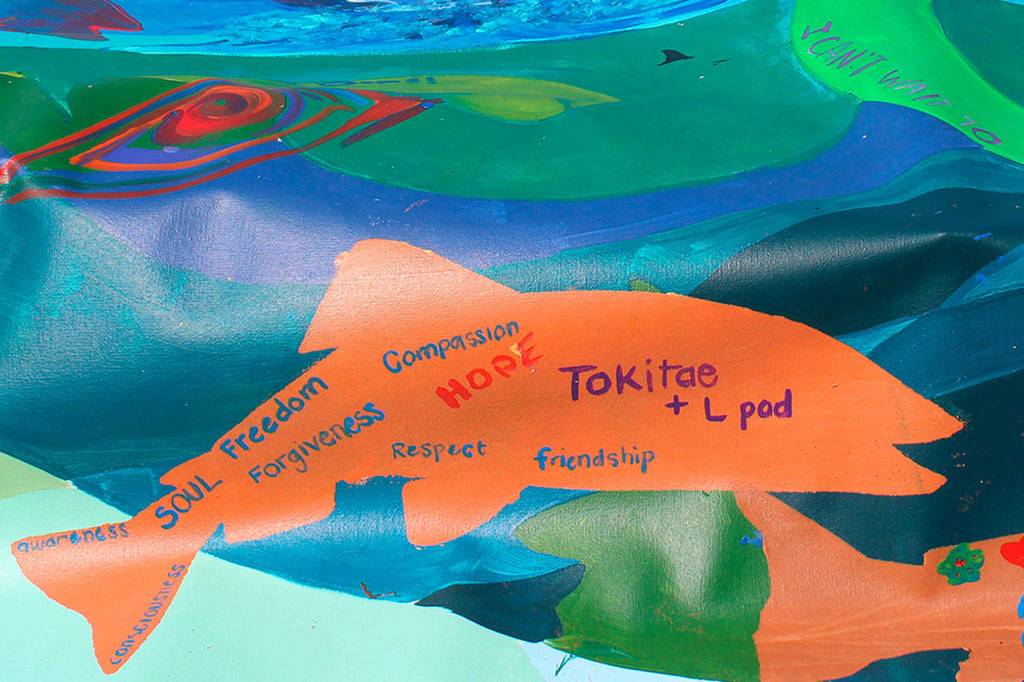 A banner at the Orca Networks Bring Tokitae Home event on Aug. 8 was painted by the Lummi Nation in honor of the orcas captured in Penn Cove in the 1960s and 70s. Tokitae/Lolita, an entertainer at the Miami Seaquarium, is the last surviving killer whale captured from her pod. (Patricia Guthrie/Whidbey News-Times)