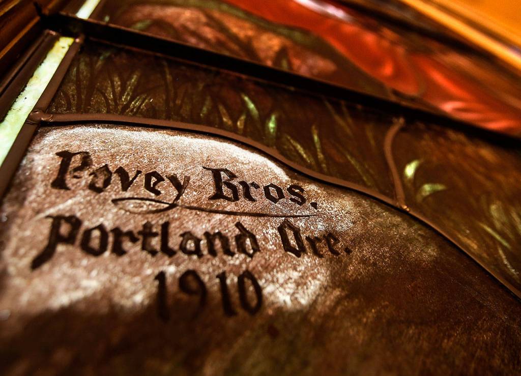 In a corner of the large stained glass window facing east at the First Presbyterian Church in Everett is the Povey Bros., of Portland, Oregon, signature, dated 1910. The window depicts Christ teaching the Parable of the Lily. (Dan Bates / The Herald)