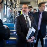 Sound Transit CEO Peter Rogoff (center) talks with King County Executive Dow Constantine while riding the light rail from Angle Lake station in September 2016. (Ian Terry / Herald file)