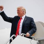President Donald Trump pumps his fist during his arrival on Air Force One at Francis S. Gabreski Airport in Westhampton, New York, on Friday, Aug. 17. (AP Photo/Pablo Martinez Monsivais)