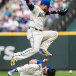 Seattle second baseman Robinson Cano jumps over teammate Mitch Haniger during Sundays game against the Los Angeles Dodgers at Safeco Field in Seattle. The Mariners lost to the Dodgers, 12-1. (Olivia Vanni / The Herald)