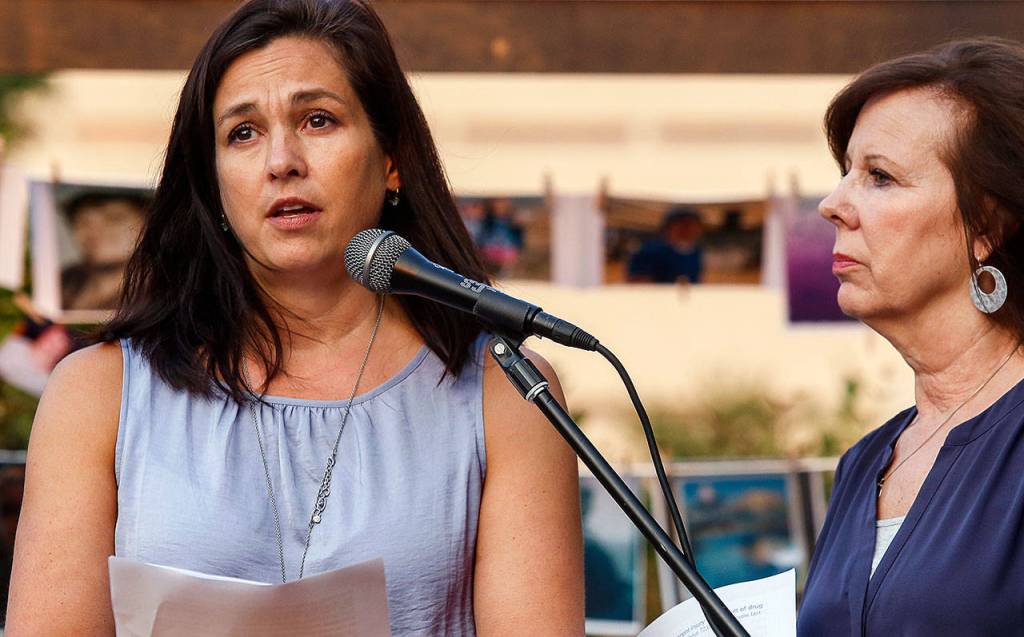 Cathi Lee (left) speaks to the crowd as Debbie Warfield, having already spoken, stays by her side. Lee lost her son, Corey, to an overdose in 2015. (Dan Bates / The Herald)
