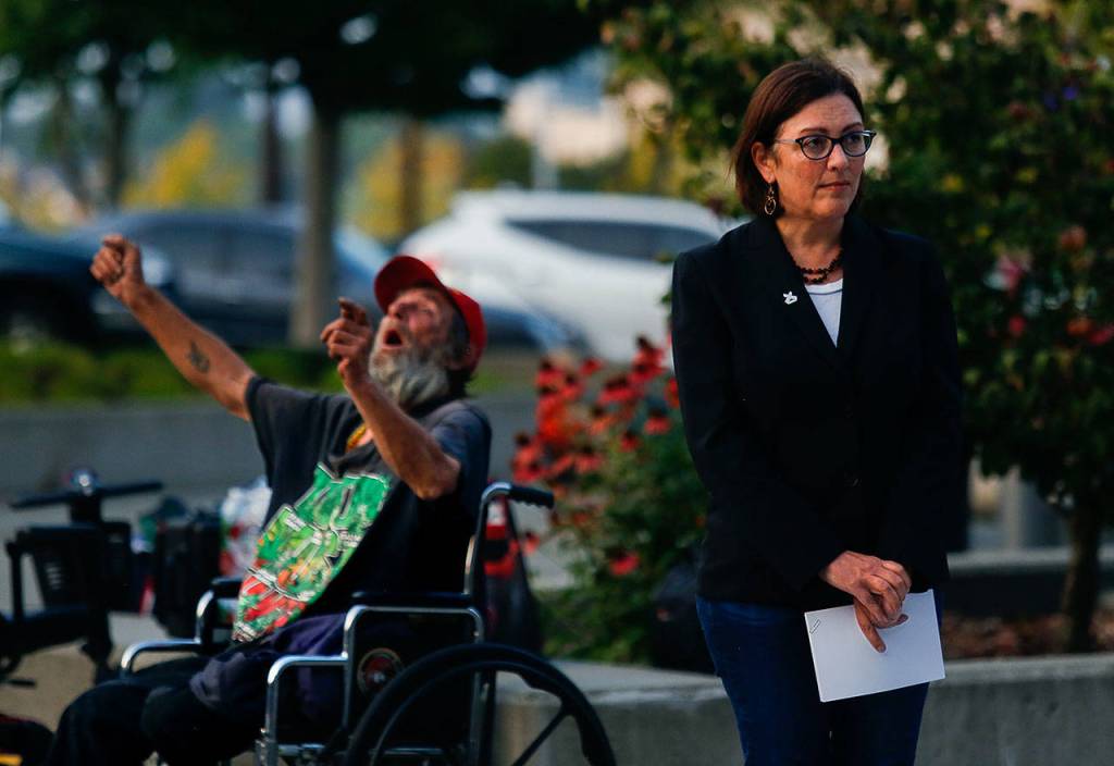 Congresswoman Suzan DelBene waits for Snohomish County Executive Dave Somers to finish speaking Thursday evening before taking her turn. (Dan Bates / The Herald)