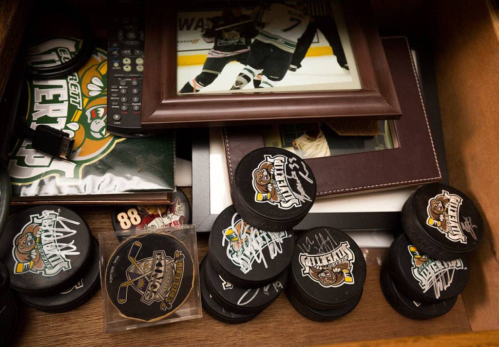 Parker Fowlds holds up a Carter Hart jersey from a closet in his Mukilteo home on Aug. 17. Hart is one of 15 players who have been billeted at Fowlds home over the life of the franchise. (Andy Bronson / The Herald)