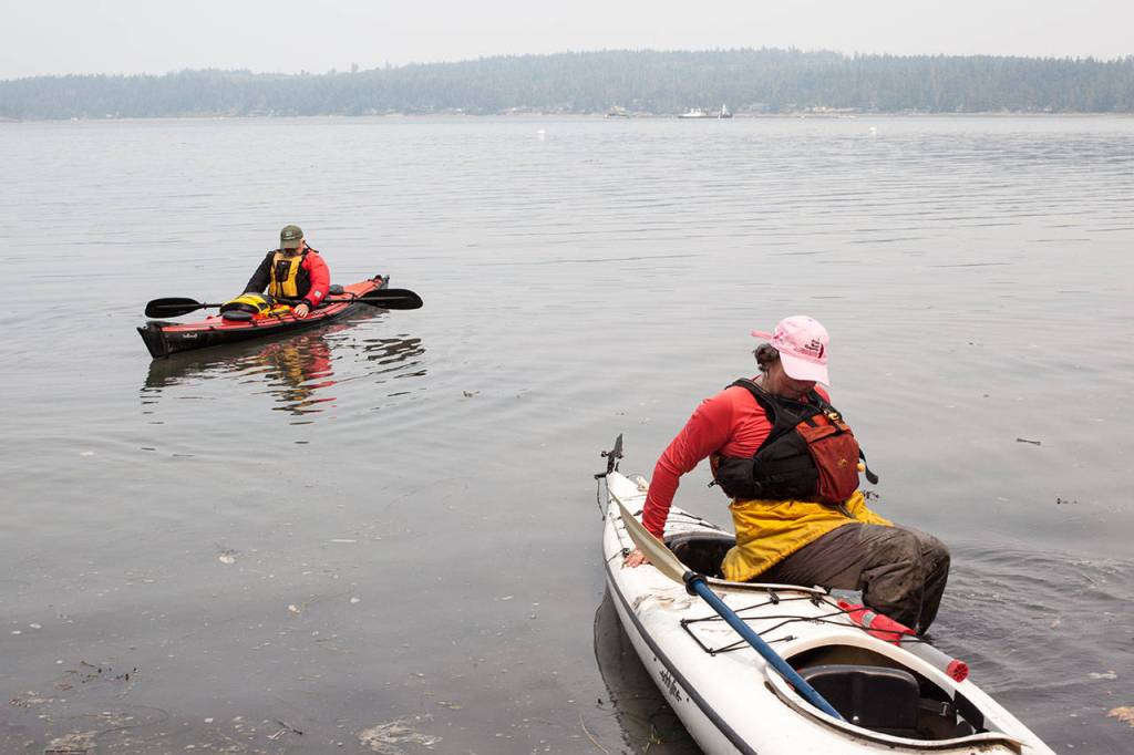 Don Crook (left) and Andrée Hurley launch their kayaks heading to Hope Island. (Lizz Giordano / The Herald)