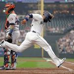 Seattles Robinson Cano crosses home plate as Houstons Martin Maldonado looks on during the first inning of the Astros x-x win over the Mariners on a hazy Monday night in Seattle. (AP Photo/Elaine Thompson)
