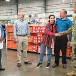 NEX Operations Manager Robin Dale (left), NEX General Manager David Franklin and U.S. Navy Capt. Michael Davis, commanding officer of Naval Station Everett (right), congratulate Bianca Brightwell, with her father Bill Brightwell, on receiving the Navy Exchanges A-OK Student Award of $2,500. (Contributed photo)