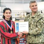 U.S. Navy Capt. Michael Davis, commanding officer of Naval Station Everett (right), congratulates Bianca Brightwell on receiving the Navy Exchanges A-OK Student Award. (Contributed photo)