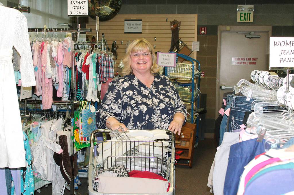Donna Morris, the new principal at Silver Lake Elementary School, helps get items ready for sale at the Assistance League of Everett thrift store for a recent service project. (Contributed photo)