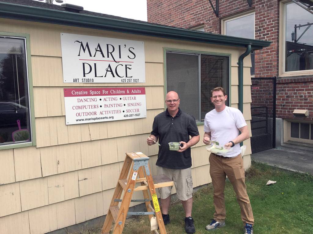 Brent Radcliff, assistant principal at Madison and Garfield elementary schools, and Sechin Tower, the new assistant principal at Jackson High School, complete a painting project at Maris Place as part of an annual service project. (Contributed photo)