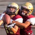 Lakewoods Cobe Matthews (left) attempts a catch with Aquarius Sherrod defending during practice on Aug. 23, 2018, at Lakewood High School in Arlington. (Kevin Clark / The Herald)