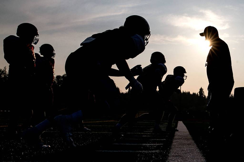 Lakewood players run through offensive line drills during practice on Aug. 23, 2018, at Lakewood High School in Arlington. (Kevin Clark / The Herald)