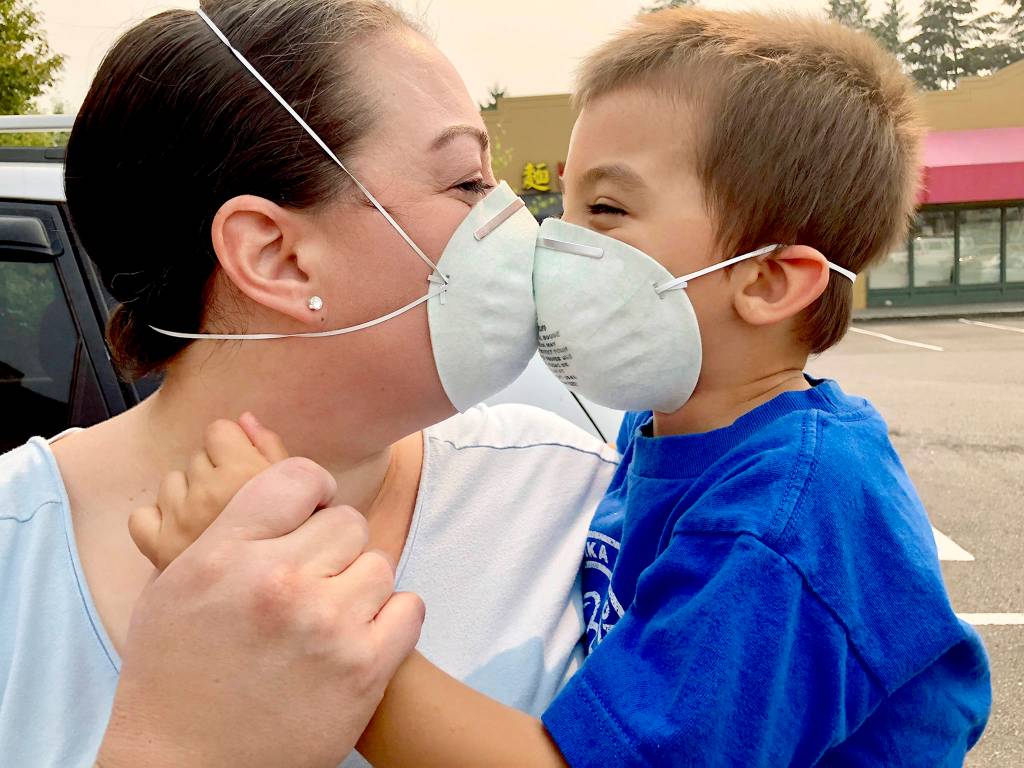 Jennifer Zahn, of Everett, bought a 10-pack of masks with the safety standard recommended for <a href="https://www.heraldnet.com/news/be-patient-meteorologists-say-relief-from-smoke-is-coming/" target="_blank">wildfire smoke</a>. Her son, Jairus, 4, doesnt seem to mind wearing one. (Andrea Brown / The Herald)