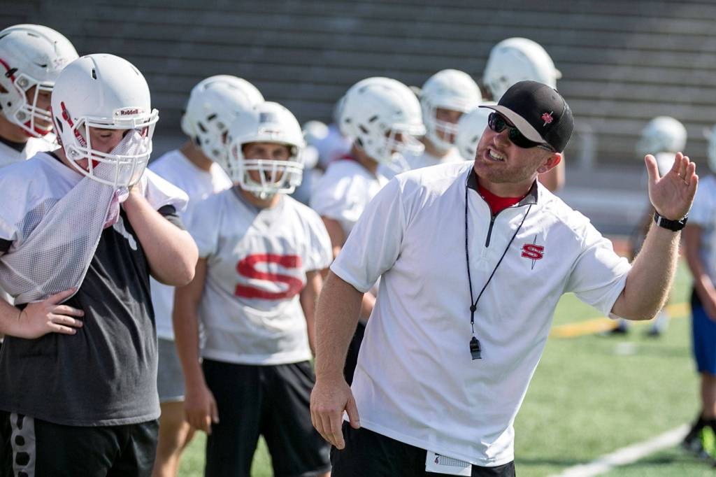 Joey Hammer addresses the team during practice Aug. 17 at Veterans Memorial Stadium in Snohomish. (Kevin Clark / The Herald)