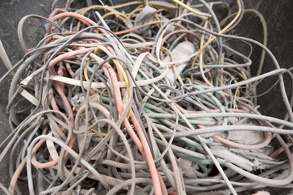 Wires that can tangle up machinery are one of the first things that sorters take out at Waste Managements recycling center Tuesday in Woodinville. (Andy Bronson / The Herald)