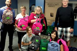 Volunteers help YWCA pack back-to-school backpacks