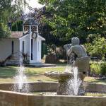 A European style fountain, multiple outbuildings and lawn sculptures dot the landscape of the old Silvana Schoolhouse. (Kevin Clark / The Herald)