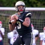 Lynnwoods Christian Kirkman looks to pass during a game against Nathan Hale on Aug. 31, 2018, at Edmonds Stadium. Kirkman decorated his arms with the jersey numbers of two teammates who died in the offseason. (Kevin Clark / The Herald)