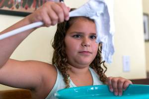 Sisters Allyea Hernandez, 8, (left) and Amaya, 10, make slime at their home in Marysville. (Kevin Clark / The Herald)