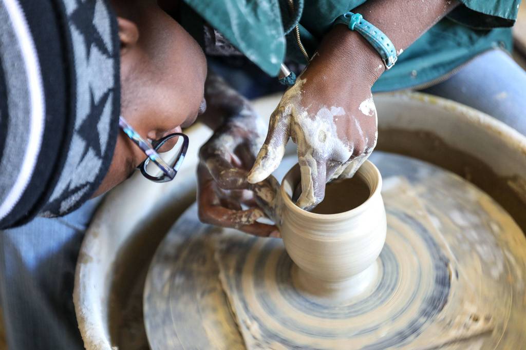 Akilah Spears, of Bruning Pottery, shows off her skills at the Makers Market hosted by the Evergreen State Fair. (Lizz Giordano / The Herald)